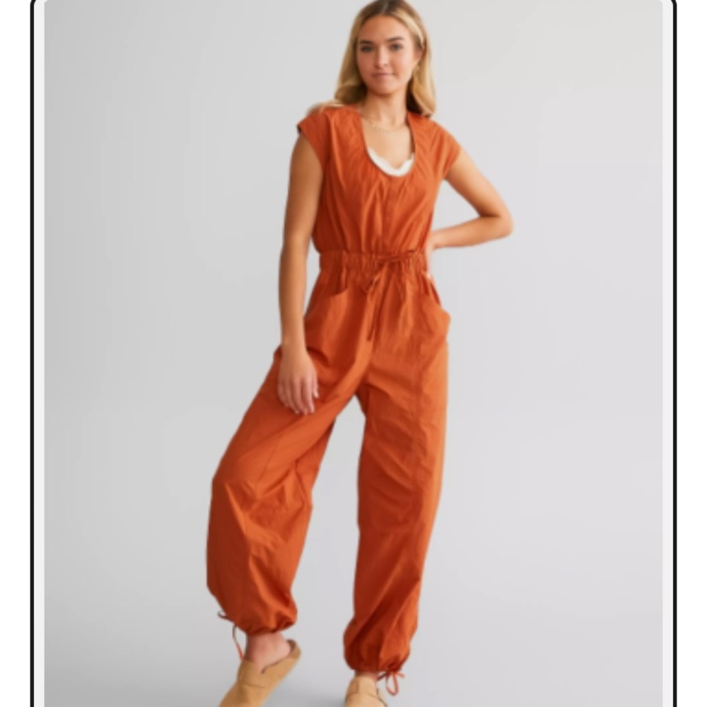 Free People Movement fly by night jumpsuit in red earth size medium